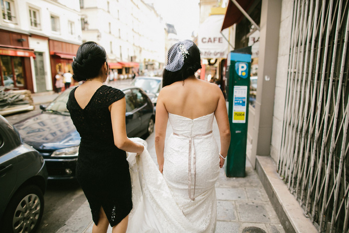 bride and maid of honor walking through Paris