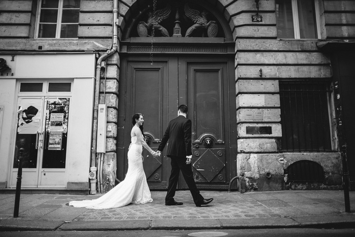 bride and groom walking through Paris