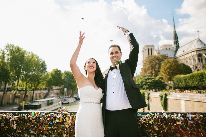 Bride and groom tossing lock keys in the seine