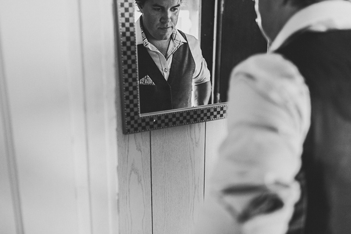 groom getting ready in front of mirror