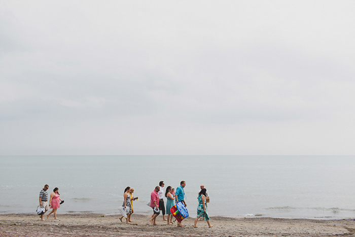 wedding guests walking on the beach