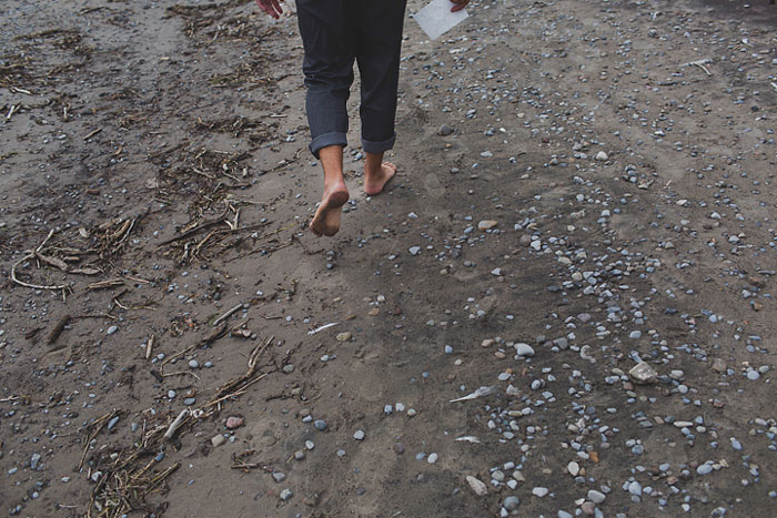 groom walking on the beach