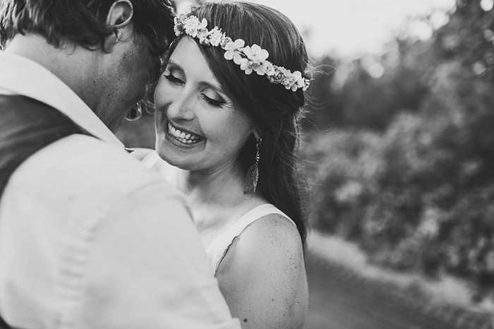 bride laughing while hugging groom