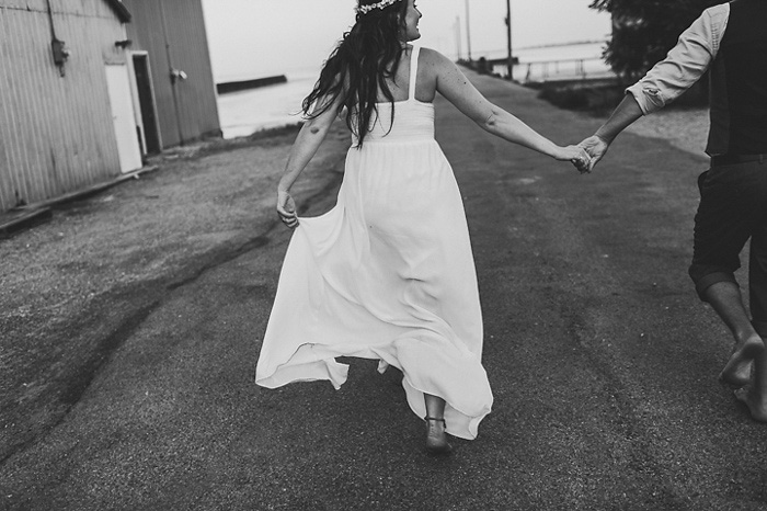 bride and groom running down road