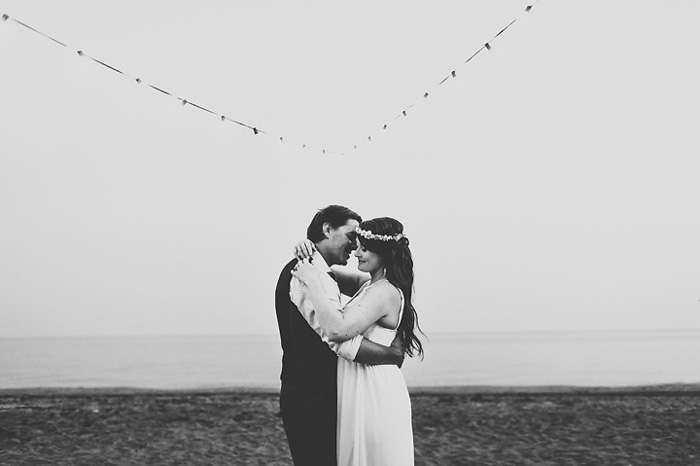 bride and groom embracing on the beach