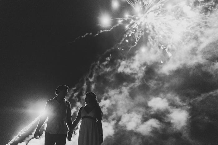 bride and groom in front of fireworks