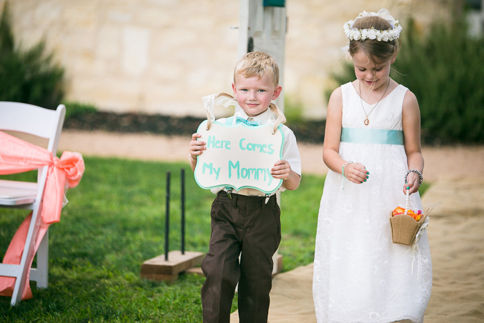 ring bearer and flower girl walking down aisle