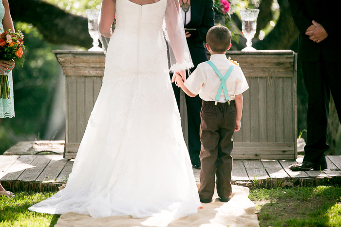 bride holding son's hand at wedding ceremony