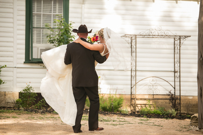 groom carrying bride