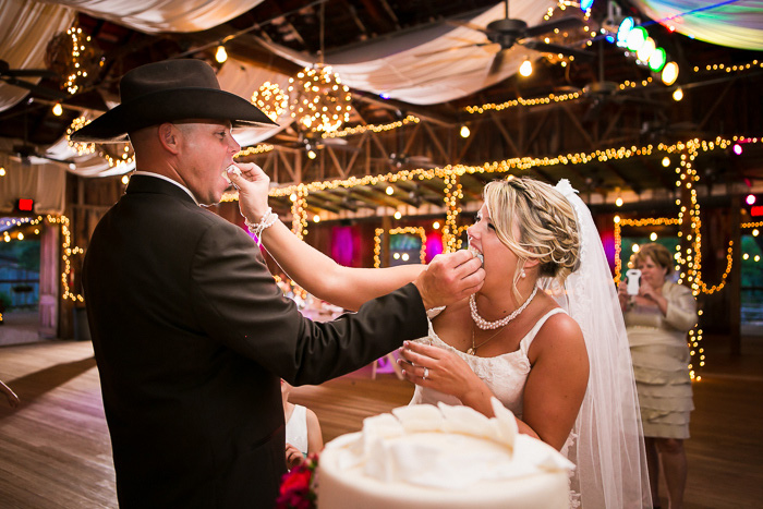 bride and groom feeding each other cake