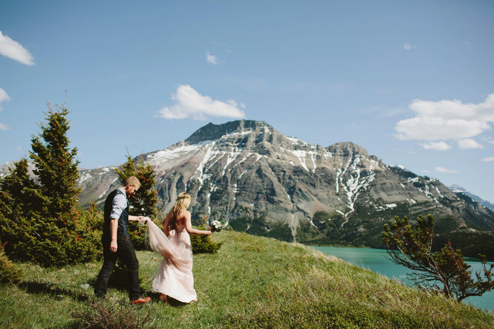 bride and groom walking through Alberta National park