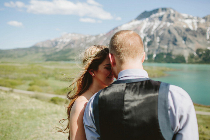 bride and groom by mountains