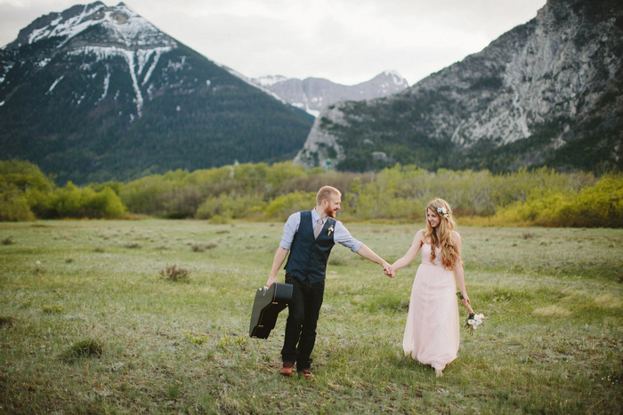 bride and groom walking through national park