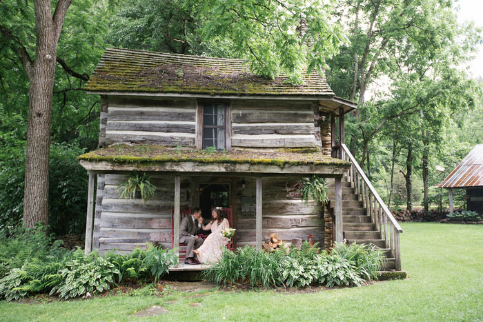 bride and groom on cabin porch