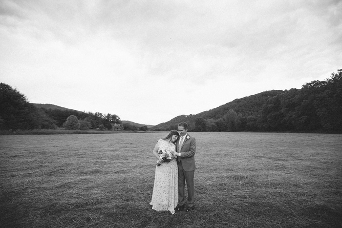 bride and groom portrait in field