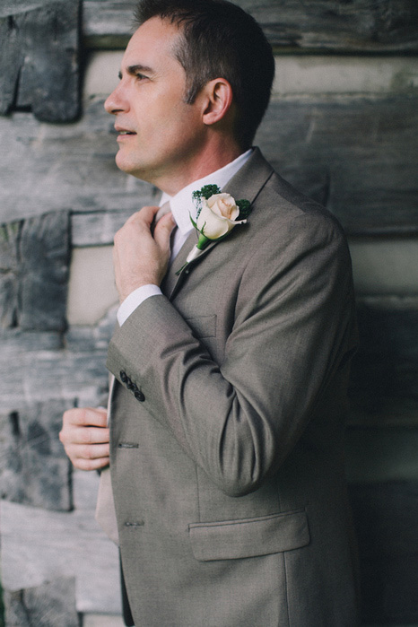 groom adjusting tie