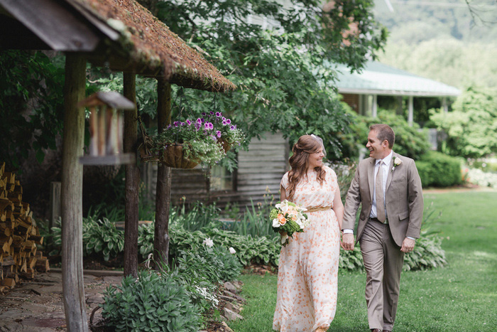 bride and groom walking on farm grounds