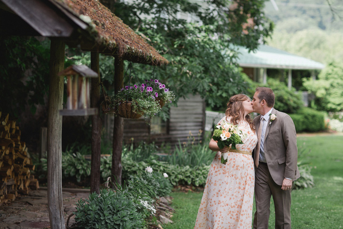 bride and groom kissing on farm grounds