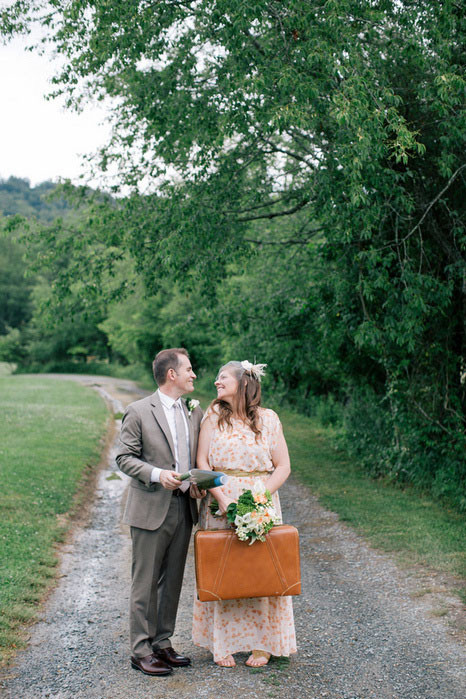 bride and groom portrait with suitcase