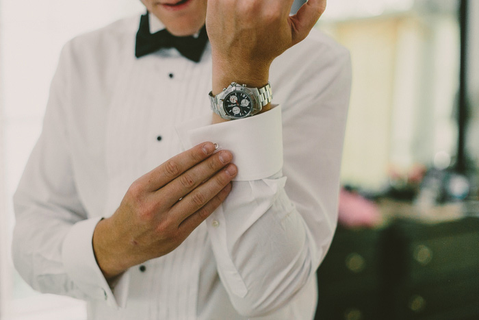 groom doing up his cuffs