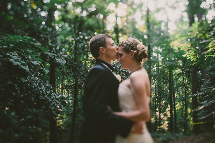 groom kissing bride on forehead