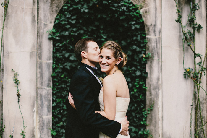 groom kissing bride on the cheek