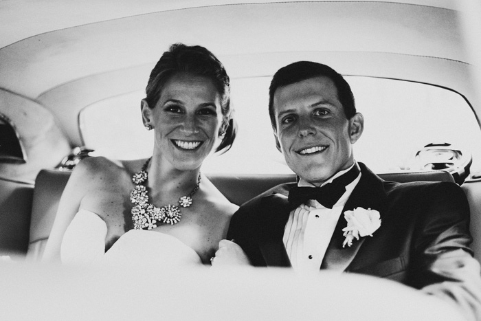 bride and groom in getaway car