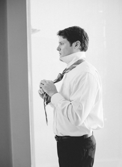 groom tying tie