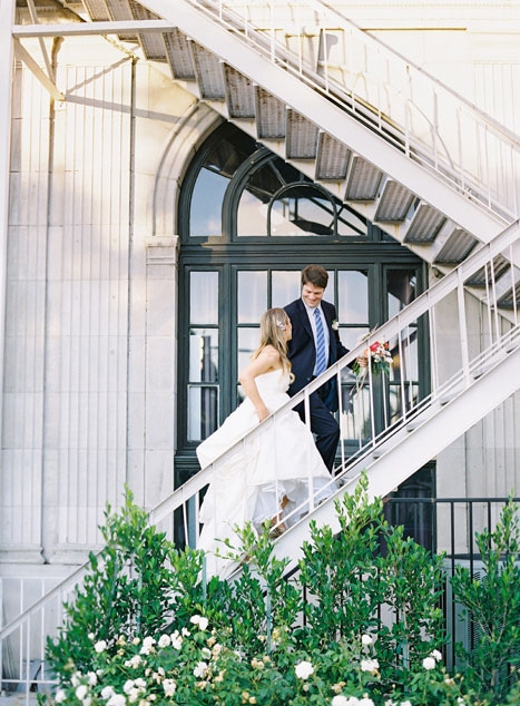 bride and groom climbing fire escape