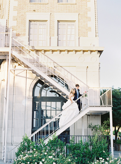 bride and groom climbing fire escape