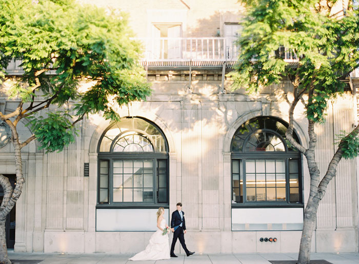 bride and groom walking down the street