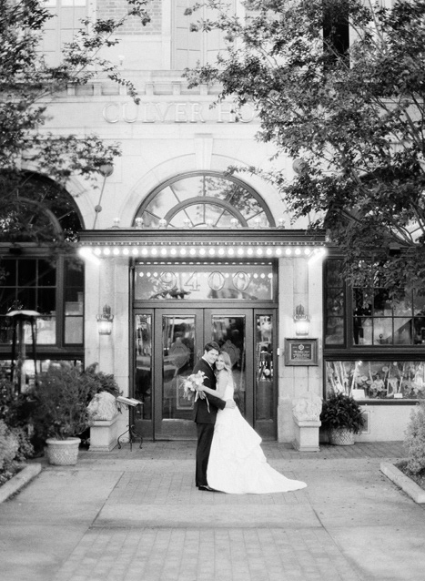 bride and groom in front of Culver Hotel