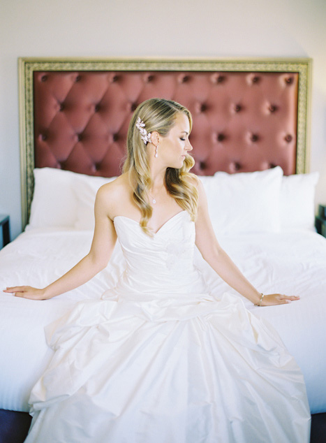 bride sitting on hotel bed