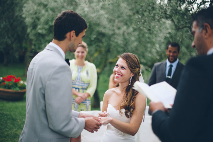 groom putting ring on bride's finger