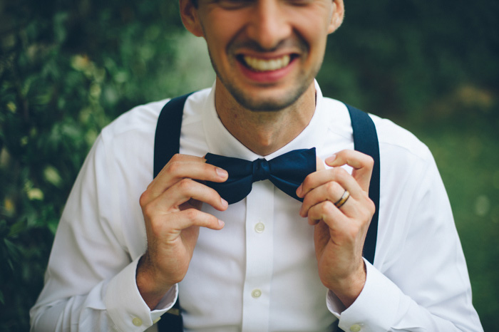 groom adjusting tie