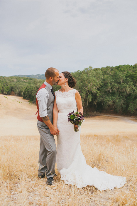 bride and groom kissing on farm