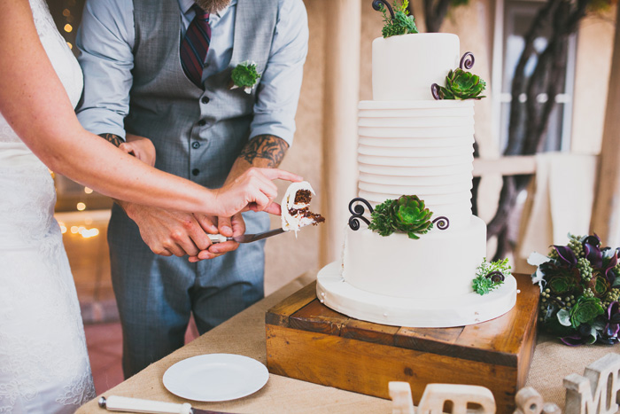 bride and groom cutting cake