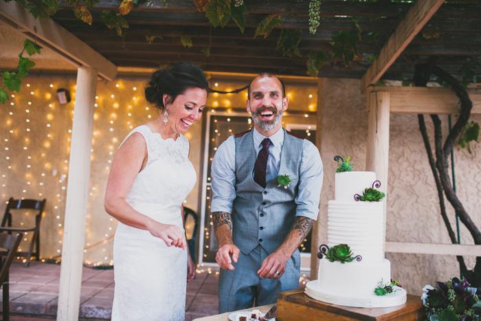 bride and groom about to cut cake