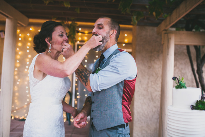 bride and groom feeing each other cake