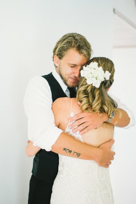 emotional groom hugging bride