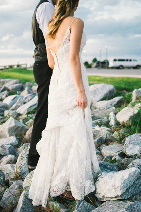 bride and groom walking on the rocks