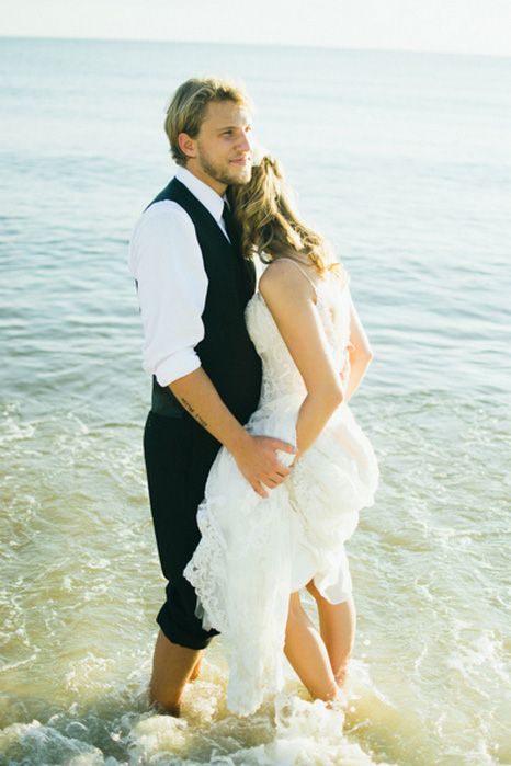 bride and groom wading in the water