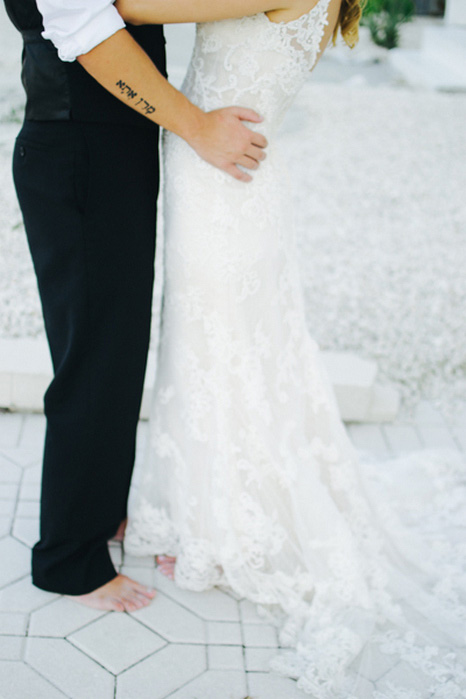 close-up of groom's hands on bride's hips