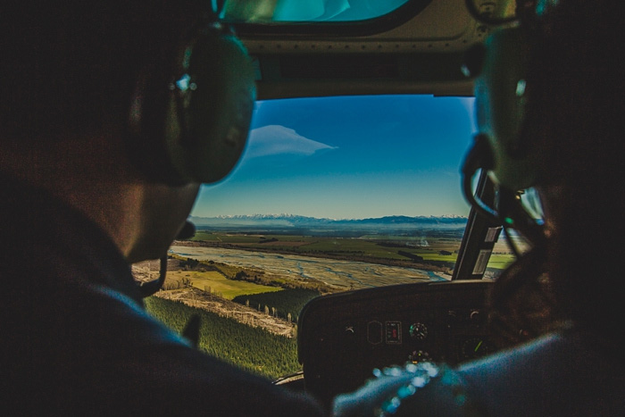 bride and groom flying in helicopter