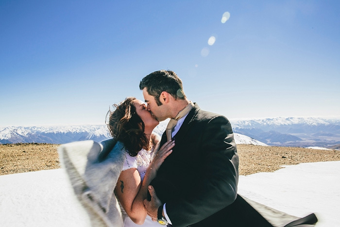 Bride and groom kissing in the snow