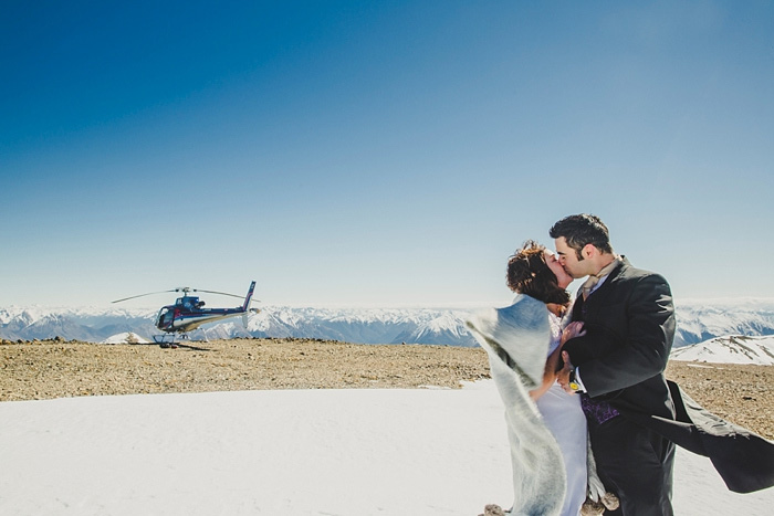 bride and groom on snowy New Zealand mountain