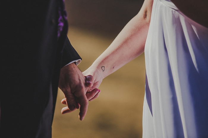 bride and groom holding hands