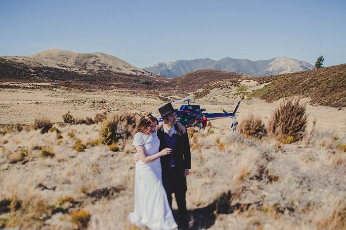 bride and groom walking on mountain