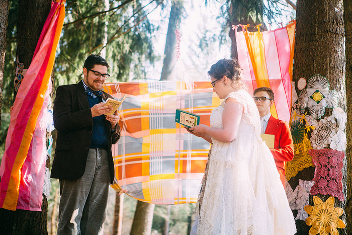 bride and groom reading vows