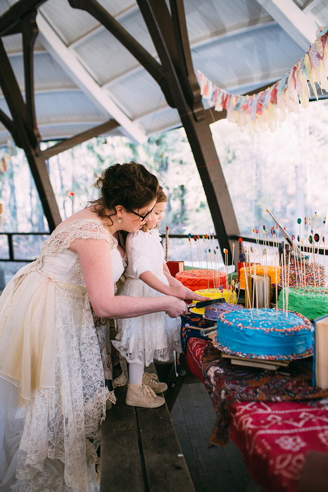 bride cutting cake with flower girl